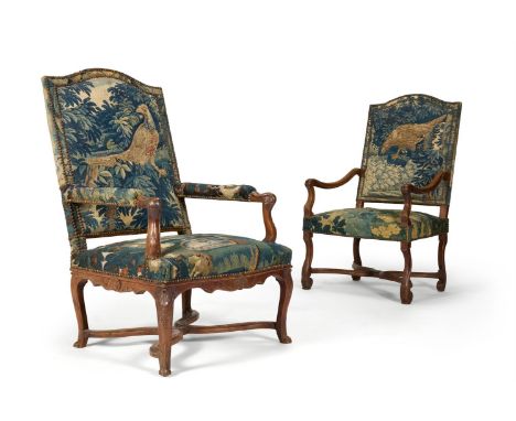 A MATCHED PAIR OF WALNUT AND VERDURE TAPESTRY UPHOLSTERED ARMCHAIRS  FRENCH, EARLY 18TH CENTURY One with shell carved cabriol