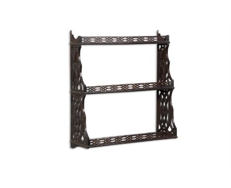 A FLIGHT OF THREE MAHOGANY WALL SHELVES IN GEORGE III STYLE 19TH CENTURY  With pierced fretwork in Chinese Chippendale style 