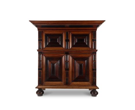 Y A DUTCH OAK, ROSEWOOD AND EBONY CUPBOARD  LATE 17TH CENTURY AND LATER  The mitre panel doors enclosing a shelved interior  