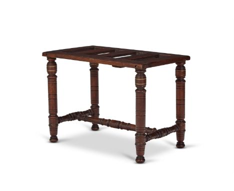 A LATE VICTORIAN STAINED BEECH AND PARCEL GILT LUGGAGE STAND  CIRCA 1900  The slatted top above the turned supports and confo