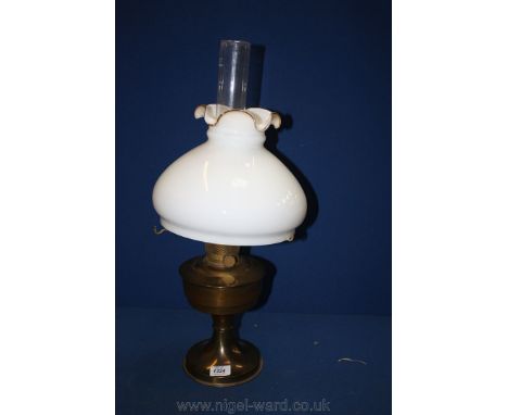 An Aladdin Brass lamp with glass funnel and white glass shade.