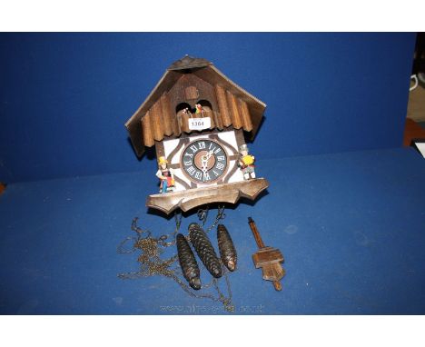 A musical Cuckoo Clock, working complete with three weights.