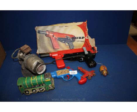 A Mettoy 'Burp' Gun, Triang pistol, template toy beetle etc and a vintage carbide Bicycle Lamp. 