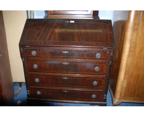 A reproduction Georgian style Mahogany finished Bureau, having plain top over the strung and cross-banded fall front, opening