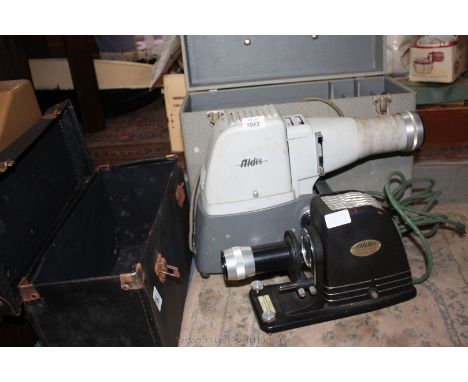 An Aldis universal projector cased and another.