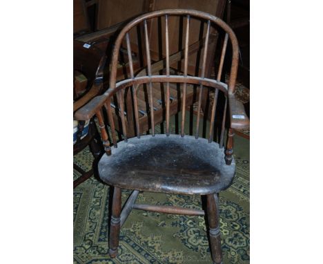 An arts and crafts primitive style Windsor type Elbow Chair, having Oak twin hoop back with Beech stick supports, heavy shape