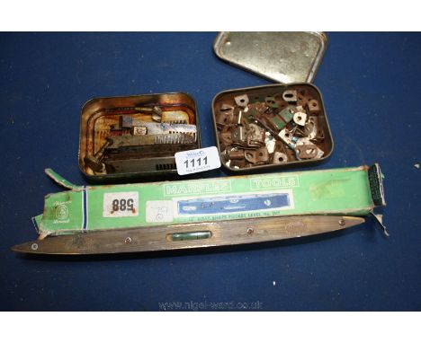 A tobacco Tin of moulding saw Blades with rack teeth for pinion adjustment, a tobacco Tin of Meccano brackets, a boxed ''Marp