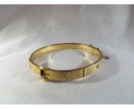 A 9ct gold belt bangle. Birmingham, 1908, Joseph Gloster. Gross weight: 8.2g