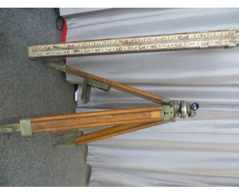 A Wild Heerbrugg NK01 engineers' level, cased, with tripod, plum, and vintage extendable measure. PLEASE NOTE THAT THIS ITEM 