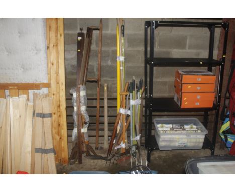 A quantity of gardening tools to include shears, digging fork, edger, pickaxe, wooden rake etc.