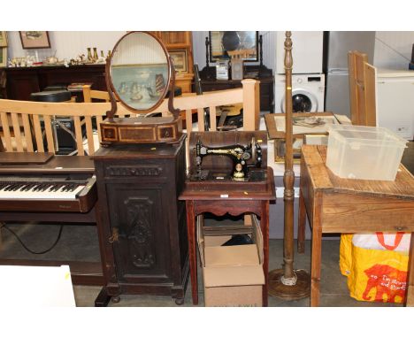 A carved oak cabinet fitted single drawer, a side table and a standard lamp