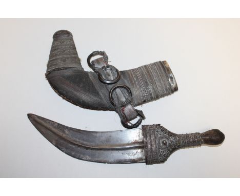 A Saidi Khanjar style dagger with white metal decorated sheath. This item can only be purchased by someone over the age of 18