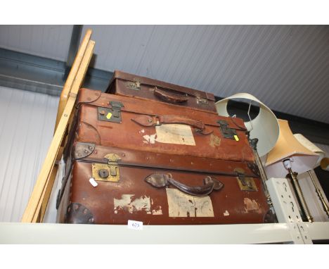 Three vintage suitcases and a folding table 