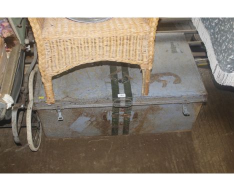 A metal storage trunk marked Mc AC with twin metal clasps and twin handles
