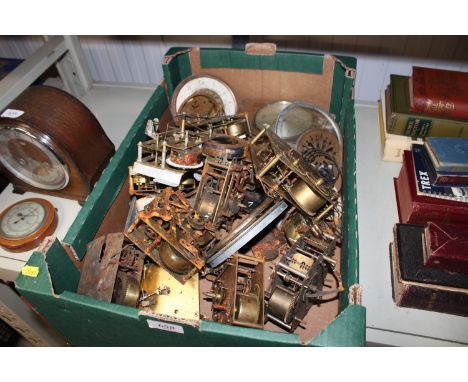 A box containing various clock parts, mantel clocks etc.