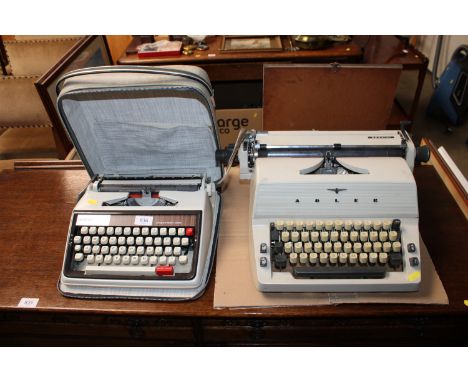 An Adler typewriter together with a Brother Deluxe typewriter