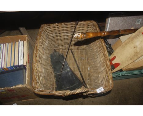 A wicker log basket, stove gloves and a small toasting fork