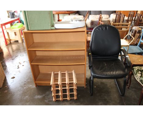 A wood effect open fronted bookcase, wine rack, a loomed storage box, a set of scales and an elbow chair