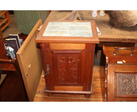 A stained pine and tile topped pot cupboard