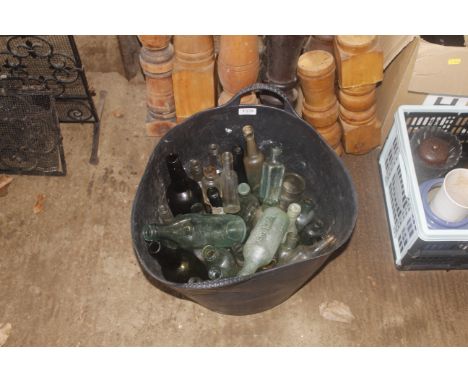A rubber trug bucket containing a quantity of various clear and brown glass bottles named to J.Talbot, Cobbold and Co Ltd Ips