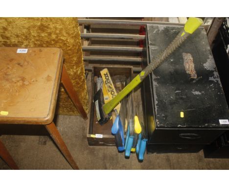 A box containing various tools to include hand saws, axe, spirit levels, crowbar