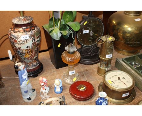 A glass oil lamp, a Rabone Chesterman Ltd tape measure and a faux plant