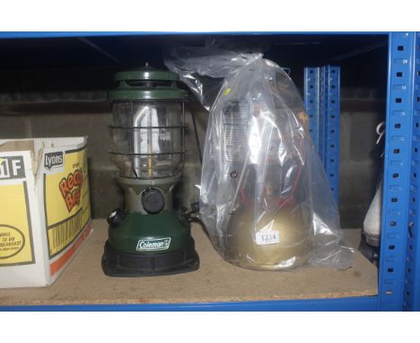 A Coleman adjustable oil lamp and one other