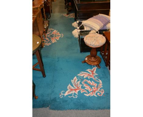 Woollen carpet, turquoise ground with a central medallion, 380cm x 270cm.