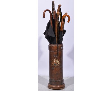 Leather munitions case, adapted as a stick stand, 58cm and a collection of walking sticks and umbrellas.