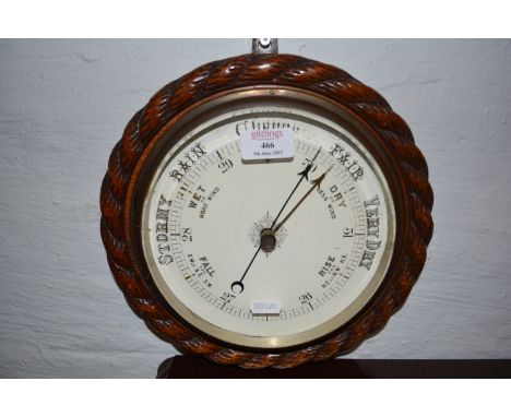 Walnut cased aneroid wall barometer, painted dial, cable moulded frame, diameter 29cm.