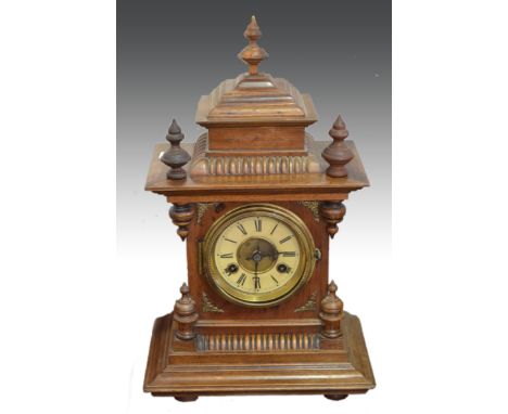 Walnut cased mantel clock, with turned field, ivorine chapter ring, movement striking on a gong, 45cm.