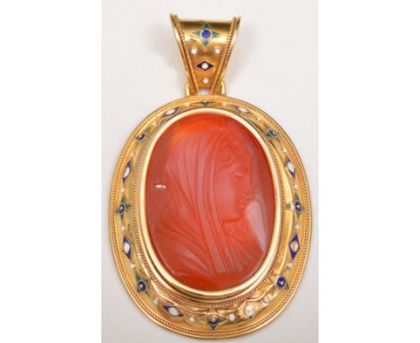Oval amber cameo pendant, yellow metal and enamelled surround.