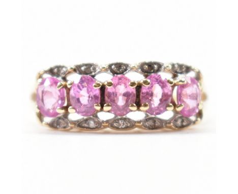 A gold diamond and pink stone ring. The ring having a row of five oval cut synthetic pink sapphire within claw settings with 