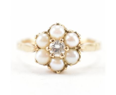 A hallmarked 9ct gold diamond and cultured pearl ring. The ring being set with a round cut diamond to the centre surrounded b