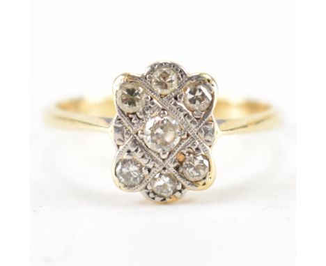 An Art Deco 18ct gold, platinum and diamond panel ring. The ring being set with seven round cut diamonds in a platinum head. 