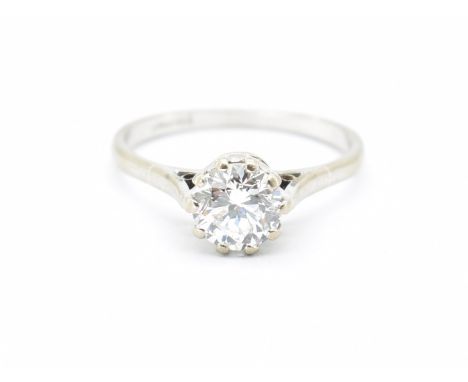 An 18ct white gold and diamond solitaire ring. The ring being claw set with a natural round brilliant cut diamond in a cathed