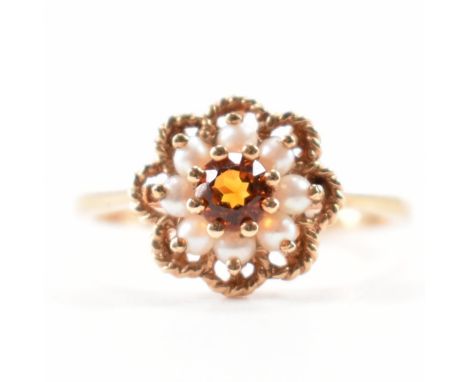 A hallmarked 9ct gold citrine and seed pearl cluster ring. The ring being set with a central round cut citrine surrounded by 