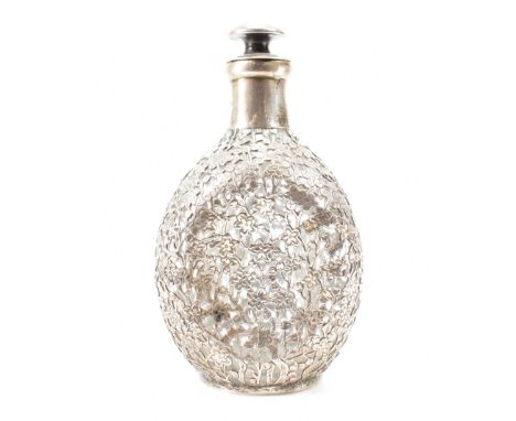 A vintage mid 20th Century Chinese silver and glass decanter bottle. The bottle having pierced prunus floral detailing to the