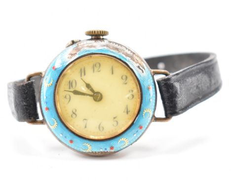 An early 20th Century antique silver and guilloche enamel wrist watch. The watch having a round face with arabic numerals to 