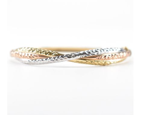An Italian gold tri-colour bangle bracelet having rows of yellow, rose and white gold in a crossover formation to top with to