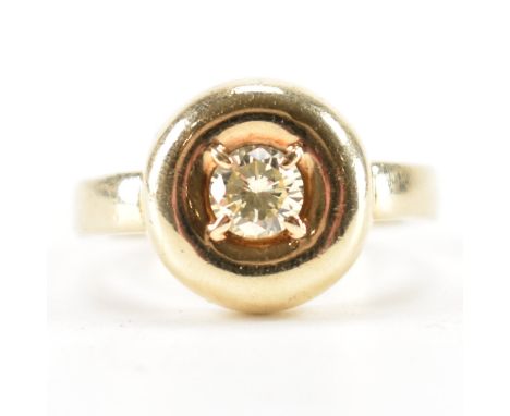 A hallmarked 9ct gold and white stone ring. The ring being set with a round brilliant cut white stone in a round head. Import