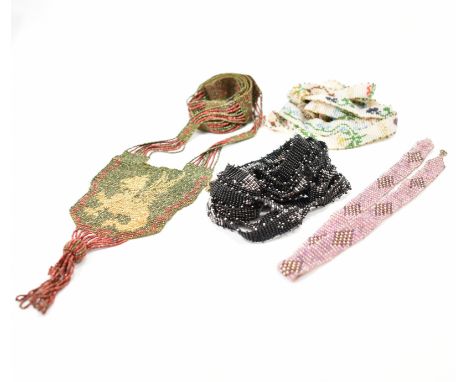 A group of four 1930s Art Deco micro bead necklaces. The lot to include a green and red necklace with a griffin panel to the 