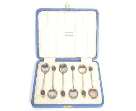 A silver hallmarked and enamel backed set of cased coffee bean spoons. Hallmarked for Birmingham 1930&nbsp; by William Suckli