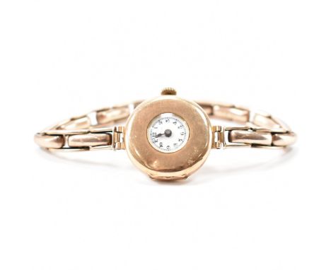 A hallmarked 9ct gold Art Deco wrist watch. The watch having a gold case and expanding bracelet strap with enamelled watch fa