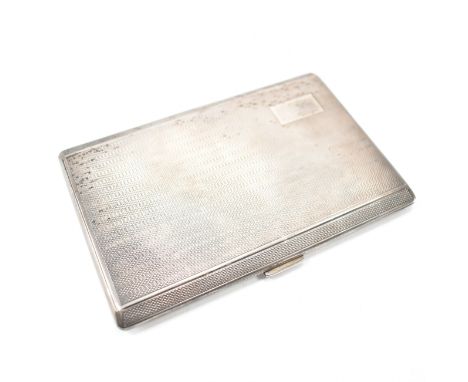 A vintage mid 20th century silver cigarette case. The case having engine turned detailing and an unengraved initial panel to 