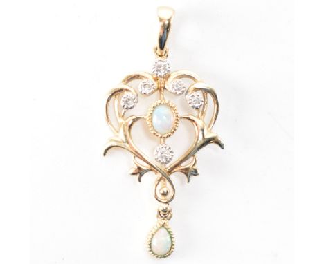 A hallmarked 9ct gold opal and diamond Art Nouveau style pendant. The pendant being set with two opal cabochons and six diamo