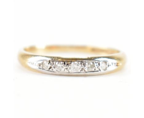 A hallmarked 9ct gold and diamond ring. The ring being set with five round cut diamonds to a plain band. Hallmarked London 19