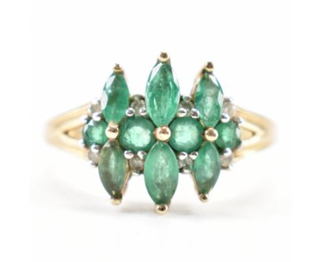 A hallmarked 9ct gold emerald and diamond cluster ring. The ring being set with six marquise cut emeralds and eight diamond a