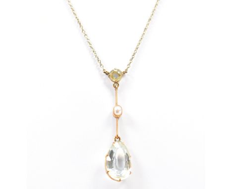 A 15ct gold and aquamarine pendant and necklace back chain. The pendant with a pear shaped aquamarine with bar link having cu