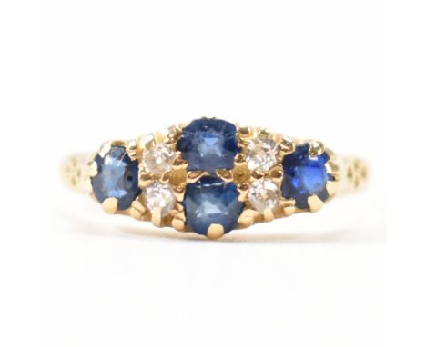A hallmarked 18ct gold diamond and sapphire cluster ring. The ring being set with four round cold cut diamonds and four round
